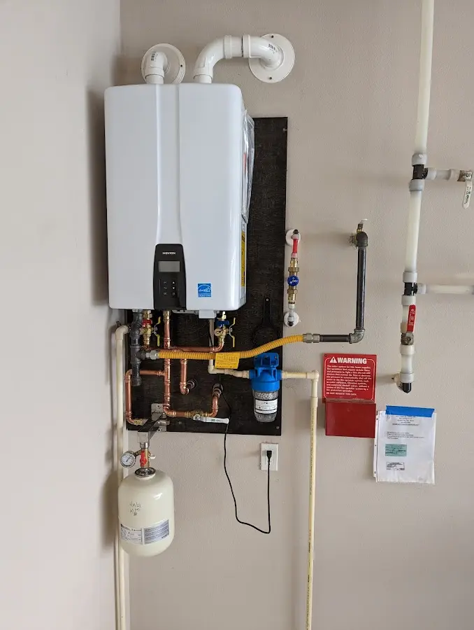 Professional plumber installing copper piping in a Belle Fourche home